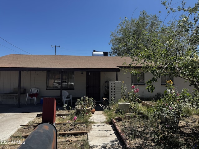 ranch-style house featuring a patio area and a shingled roof