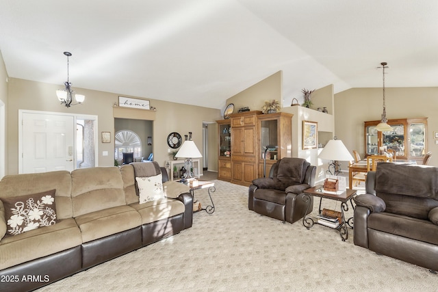 living room with carpet floors, lofted ceiling, and a notable chandelier