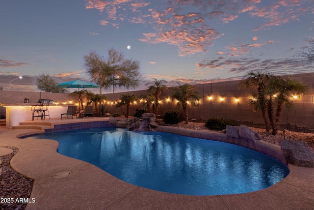 view of pool featuring outdoor dry bar, a patio area, a fenced backyard, and a fenced in pool