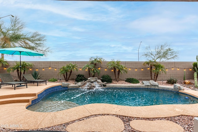 view of pool with a fenced backyard, a fenced in pool, and a patio