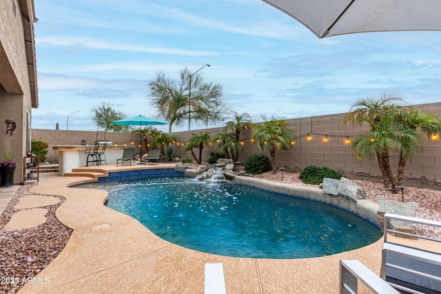 view of pool with a fenced backyard, outdoor dry bar, a fenced in pool, and a patio