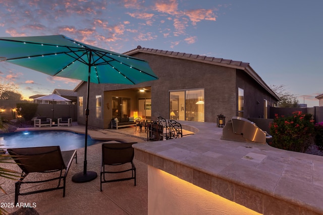 pool at dusk featuring a patio area, a fenced backyard, a fenced in pool, and a grill