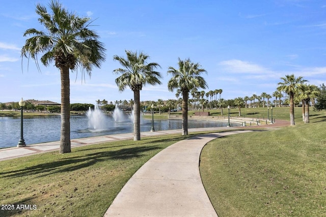 view of home's community featuring a yard and a water view