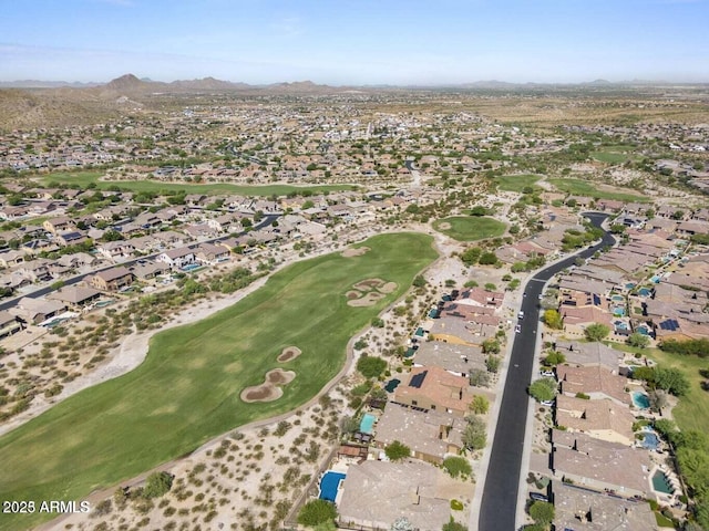 drone / aerial view with golf course view, a residential view, and a mountain view