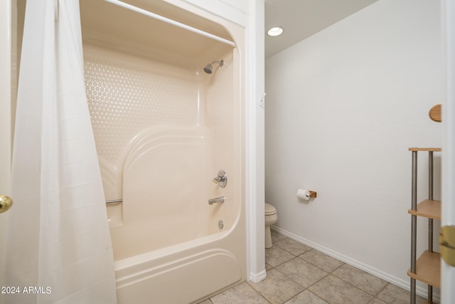 bathroom featuring shower / bath combo, tile patterned flooring, and toilet