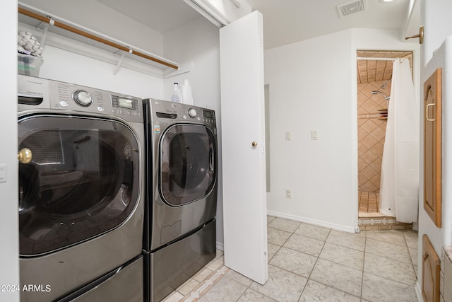 washroom featuring washer and clothes dryer