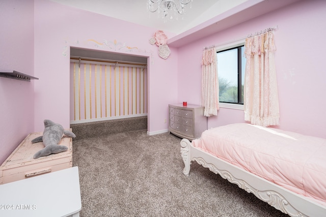 carpeted bedroom with a notable chandelier