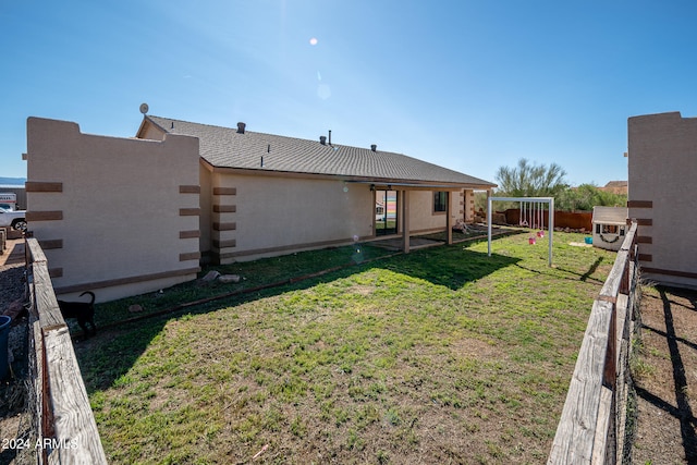 back of house with a yard