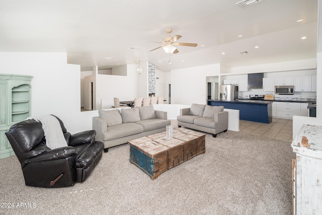 living room featuring ceiling fan, light tile patterned flooring, and lofted ceiling