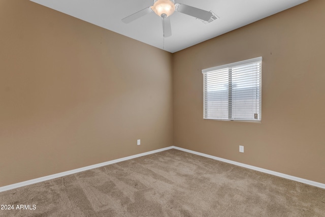 spare room with light carpet and ceiling fan