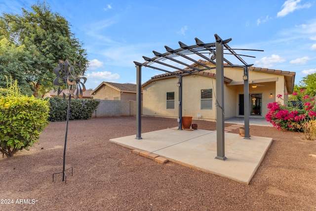 back of property featuring a patio area and a pergola