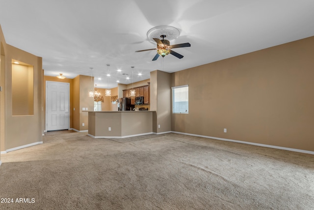 unfurnished living room featuring light carpet and ceiling fan