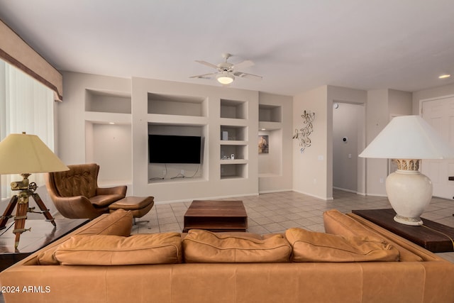 tiled living room featuring ceiling fan and built in features