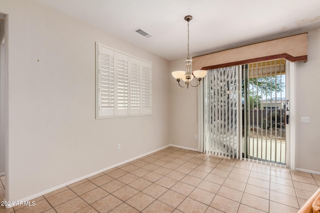 interior space featuring light tile patterned flooring and an inviting chandelier