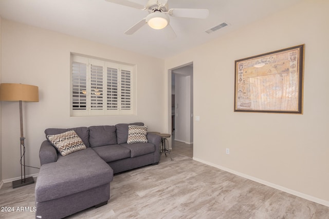 living room with light hardwood / wood-style floors and ceiling fan