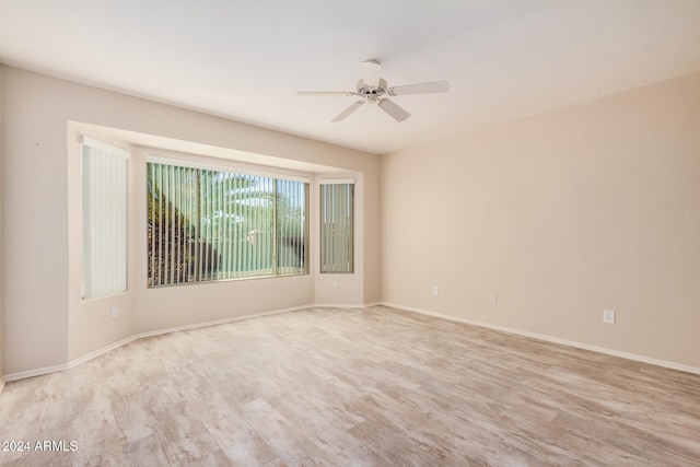 unfurnished room with ceiling fan and light wood-type flooring