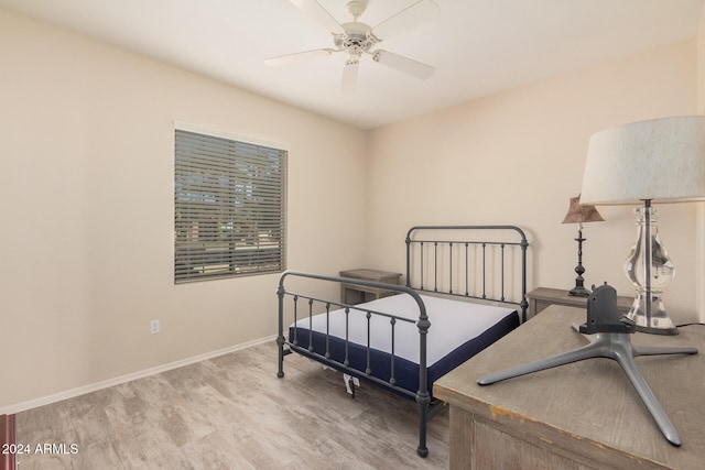 bedroom with light hardwood / wood-style floors and ceiling fan