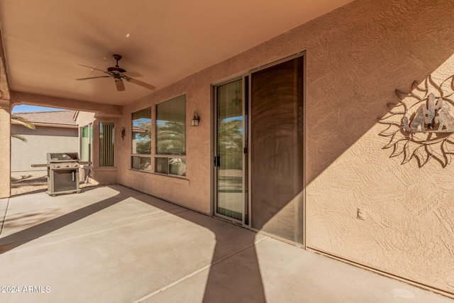 view of patio with a grill and ceiling fan