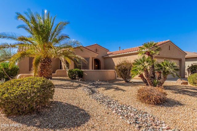 mediterranean / spanish-style home with a garage