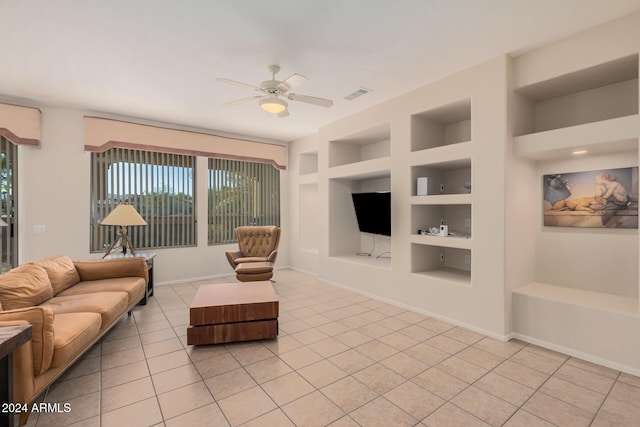 tiled living room featuring ceiling fan and built in features