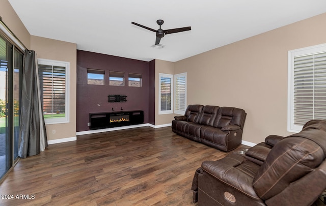 living room with ceiling fan and dark wood-type flooring