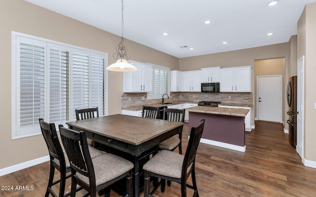 dining area with dark hardwood / wood-style flooring and sink