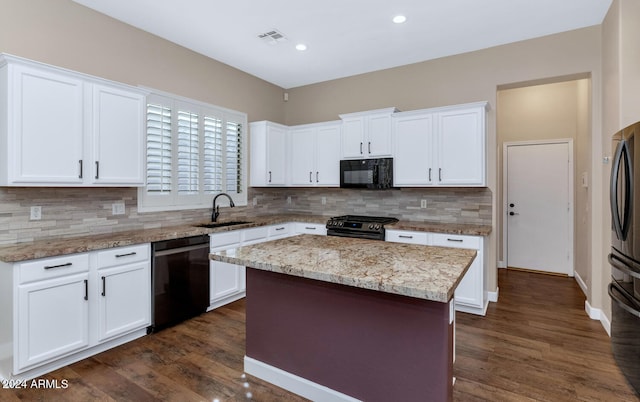 kitchen with white cabinetry, dark wood-type flooring, a kitchen island, and black appliances