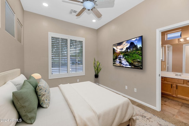 bedroom with ceiling fan, sink, and ensuite bath