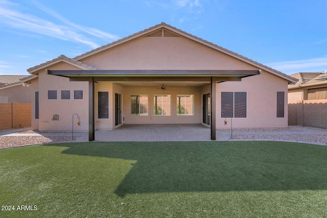 rear view of house with a yard, a patio, and ceiling fan