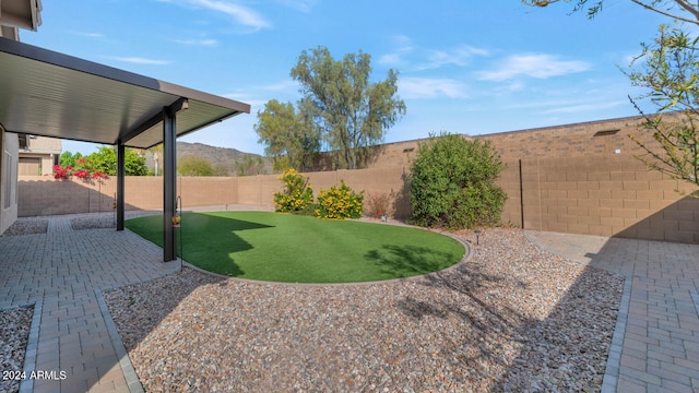 view of yard featuring a mountain view and a patio