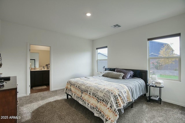 carpeted bedroom featuring ensuite bathroom