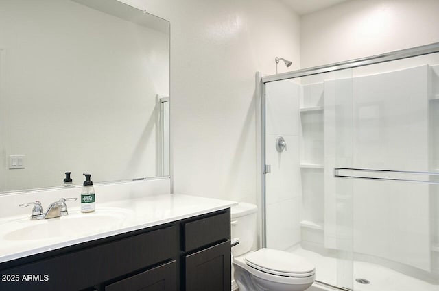 bathroom with vanity, toilet, and walk in shower