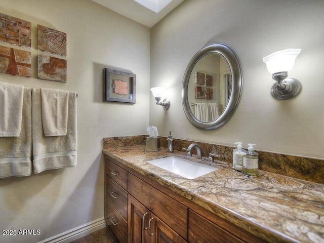 bathroom with vanity and a skylight