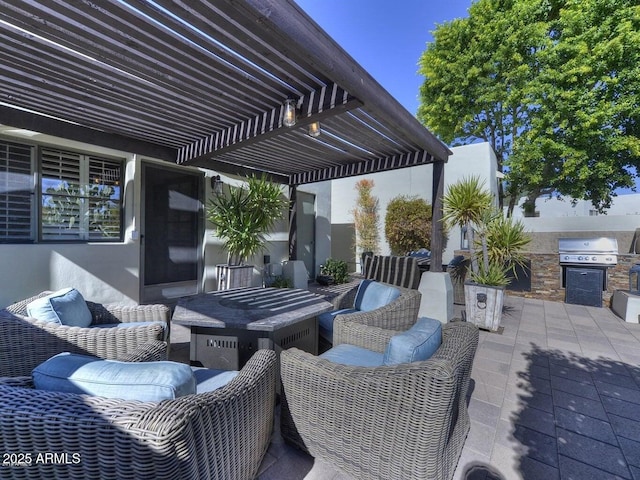 view of patio featuring a grill, a pergola, an outdoor hangout area, and exterior kitchen