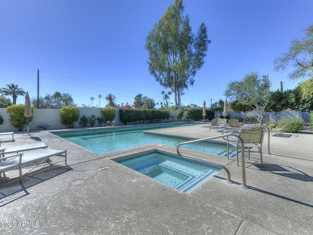 view of swimming pool featuring an in ground hot tub and a patio