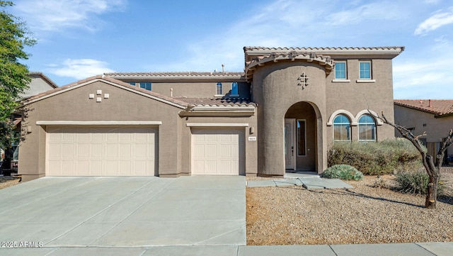 mediterranean / spanish home featuring a garage