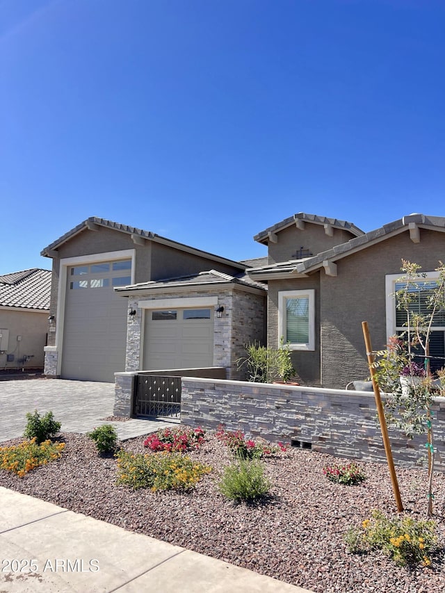 11074 W Tonto St, Avondale, AZ 85323 - view of front of house featuring a garage, driveway, and stucco siding