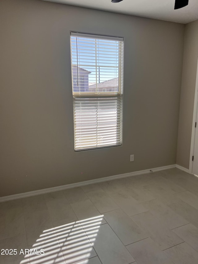 11074 W Tonto St, Avondale, AZ 85323 - empty room with light tile patterned floors, baseboards, and a ceiling fan