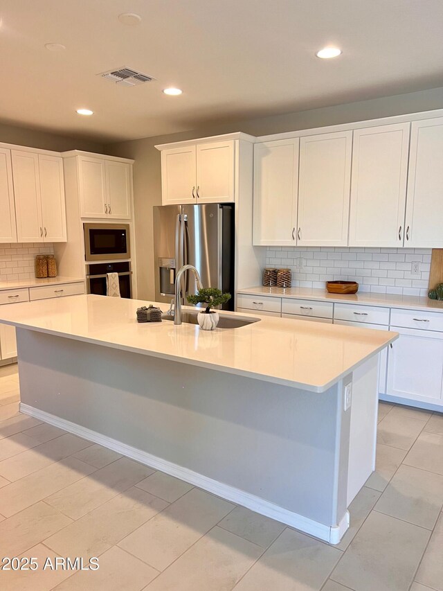 11074 W Tonto St, Avondale, AZ 85323 - kitchen featuring backsplash, built in microwave, wall oven, a sink, and stainless steel fridge