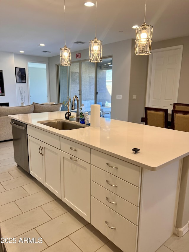 11074 W Tonto St, Avondale, AZ 85323 - kitchen featuring open floor plan, light countertops, white cabinetry, a sink, and dishwasher
