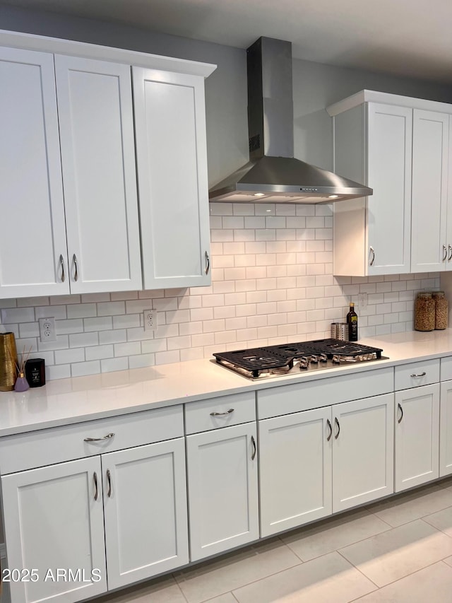 11074 W Tonto St, Avondale, AZ 85323 - kitchen featuring light countertops, tasteful backsplash, wall chimney range hood, and stainless steel gas stovetop