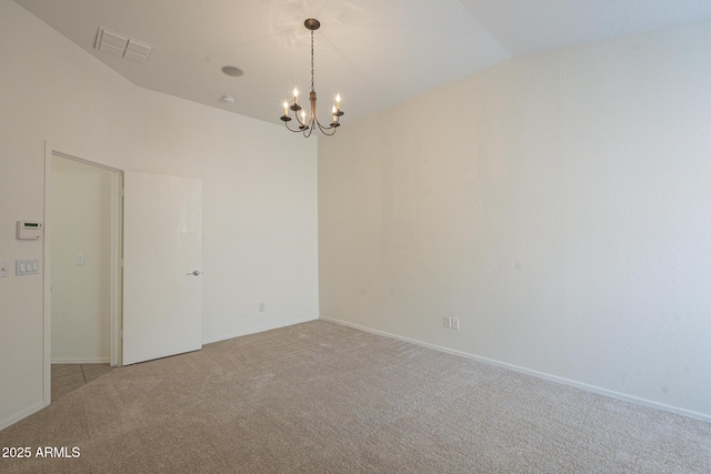 carpeted empty room with an inviting chandelier and vaulted ceiling