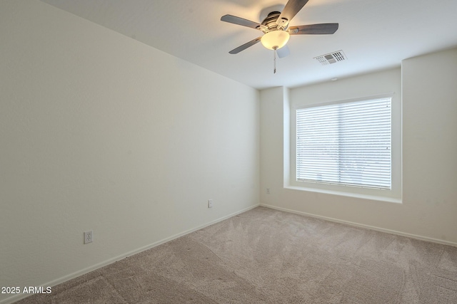 spare room featuring ceiling fan and carpet