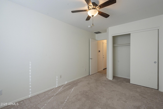 unfurnished bedroom with light carpet, a closet, and ceiling fan