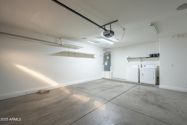 garage with a garage door opener, washer and clothes dryer, and water heater