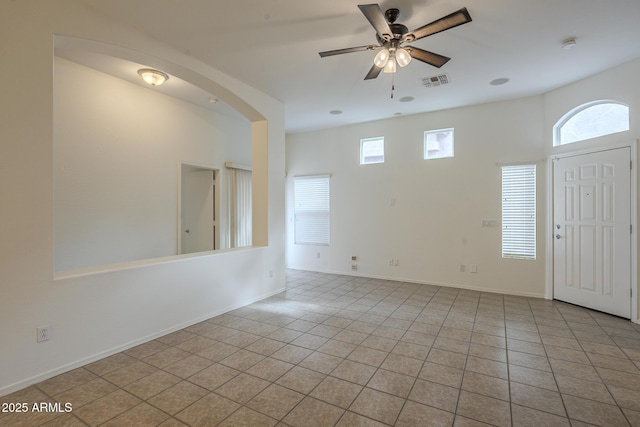 empty room featuring light tile patterned floors and ceiling fan