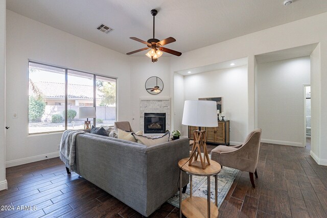 living room featuring dark hardwood / wood-style flooring and ceiling fan