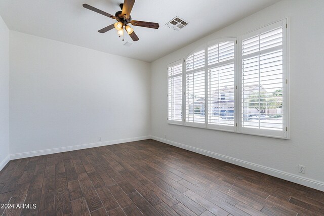 spare room with ceiling fan and dark hardwood / wood-style flooring