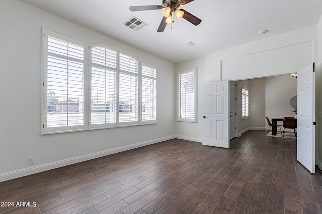 spare room featuring ceiling fan and dark hardwood / wood-style flooring