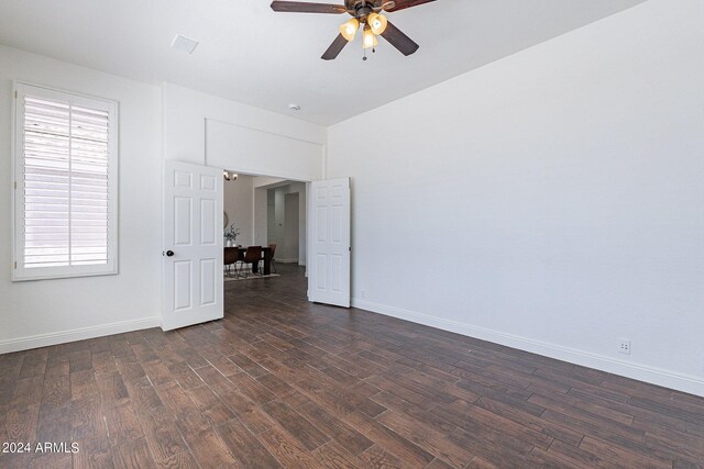 spare room with ceiling fan and dark wood-type flooring